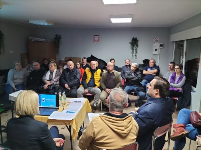 Fotografia przedstawia zebranych na zebraniu sołeckim w gminie Pleszew z władzami miasta i gminy