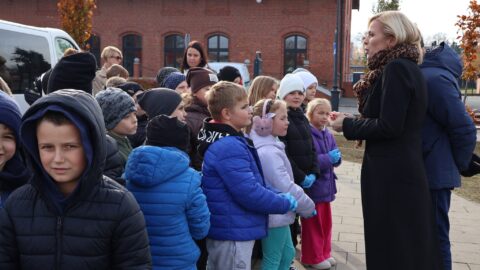 Dzieci przygotowujące się do sadzenia roślin na skwerze przy pleszewskiej bibliotece