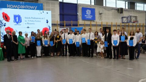 grupowe zdjęcie nagrodzonych absolwentów podczas gali.